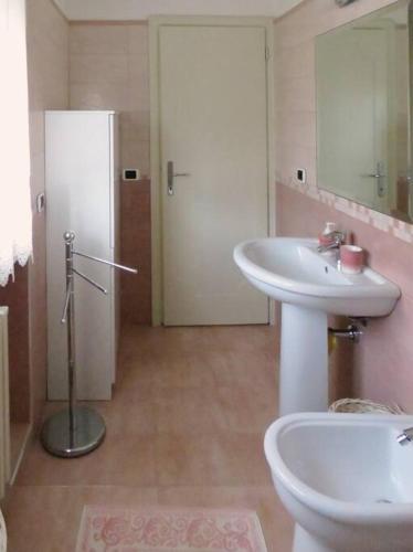 a bathroom with a sink and a toilet and a mirror at Villa Mare in Forte dei Marmi