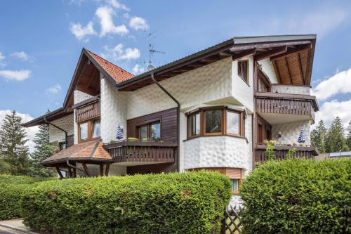 a large house with wooden balconies on it at Oskar im Bärenhüsli in Titisee-Neustadt