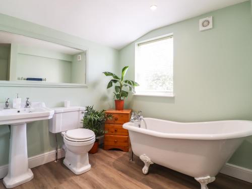 a bathroom with a tub and a toilet and a sink at Hertford Street in Cambridge