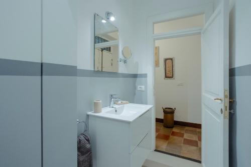a white bathroom with a sink and a mirror at Home d'Elite Navona - Pantheon in Rome