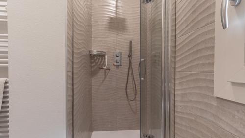 a shower with a glass door in a bathroom at -Le stanze dei Pico- Wi-Fi, nel cuore di Mirandola - una terrazza unica sul tetto in Mirandola