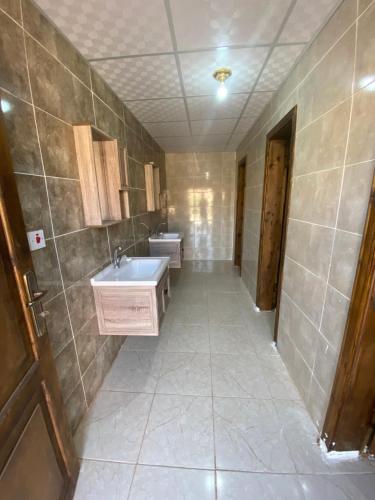 a bathroom with two sinks and two toilets at Bilal luxury camp in Wadi Rum