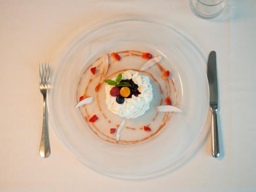 a plate with a dessert on a table with a fork and knife at Hotel Pian del Sole in Sassello