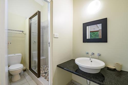 a bathroom with a sink and a toilet at San Lameer Villa 3014 - 3 Bedroom Classic - 6 pax - San Lameer Rental Agency in Southbroom