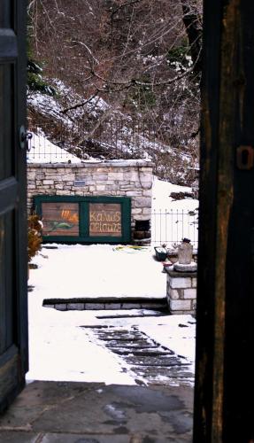 a gate with a sign in the snow at Gaia Guesthouse in Dilofo