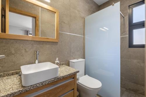 a bathroom with a sink and a toilet at Salsa Country House II by Madeira Sun Travel in Porto Moniz