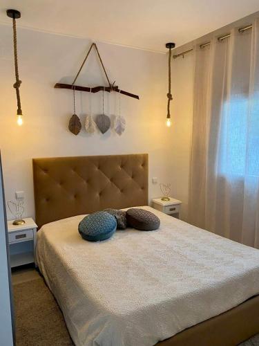 a bedroom with a bed with two pillows on it at Alto do Moinho in Alcobaça