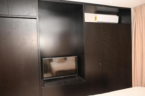 a black wall with a tv in a room at The Broadway @The Lennox in Accra