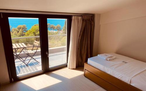 a bedroom with a bed and a large window with a view at Olivia Estate Villa with Private Swimming Pool in Elia