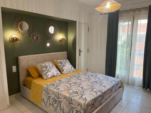 sypialnia z łóżkiem i 2 lustrami na ścianie w obiekcie Bel appartement à Perpignan w Perpignanie