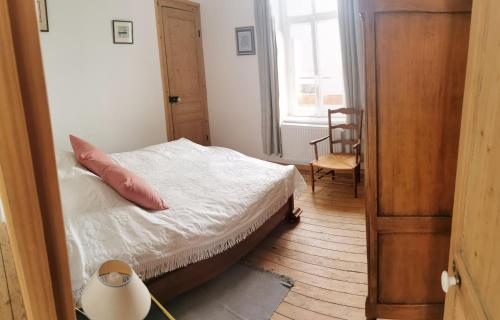 une chambre avec un lit, une chaise et une fenêtre dans l'établissement Le Clos du Hesdre, à Neufchâtel-Hardelot