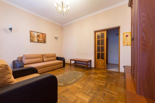 a living room with a couch and a table at Cheap Apartments in Kyiv