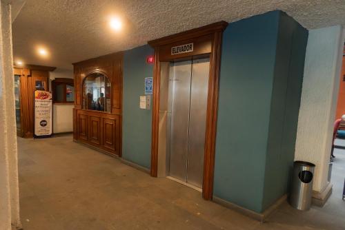 an empty hallway of a building with a elevator at Hotel Santiago De Compostela - Guadalajara Centro Historico in Guadalajara