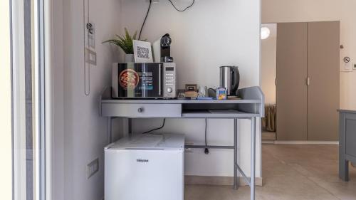 a kitchen with a table with a coffee maker on it at -Le stanze dei Pico- Wi-Fi, nel cuore di Mirandola - una terrazza unica sul tetto in Mirandola