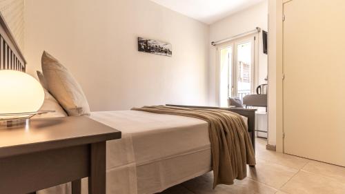 a bedroom with a bed and a desk and a window at -Le stanze dei Pico- Wi-Fi, nel cuore di Mirandola - una terrazza unica sul tetto in Mirandola