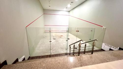 a room with a large glass wall at Centaurus Apartment Mountain View Two Bedroom in Islamabad