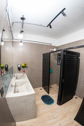 a large bathroom with a sink and a shower at Pura Vida Hostel in Rio de Janeiro