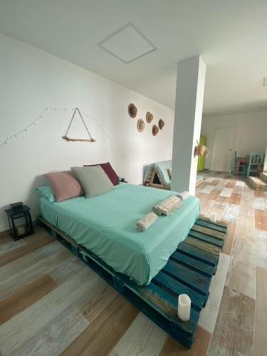 a bedroom with a bed in the middle of a room at Casa Mediterránea in Vilassar de Dalt