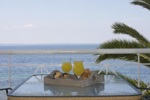 a tray with two glasses of orange juice on a table at Porto Psakoudia in Psakoudia