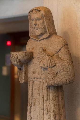 a stone statue of a man holding a bowl at Hotel Santiago De Compostela - Guadalajara Centro Historico in Guadalajara