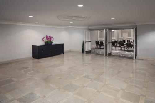 a large room with a lobby with tables and chairs at DoubleTree Suites by Hilton Hotel Detroit Downtown - Fort Shelby in Detroit