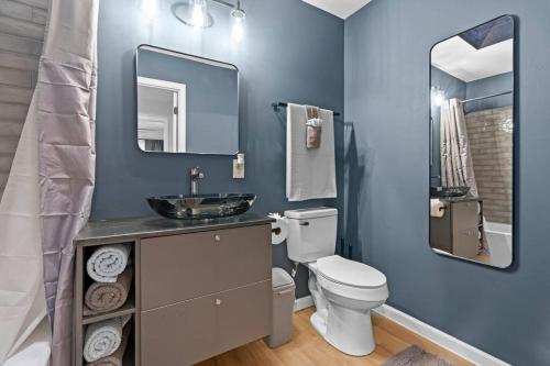 a bathroom with a toilet and a sink and a mirror at Gainesville-newly remodeled home in Gainesville