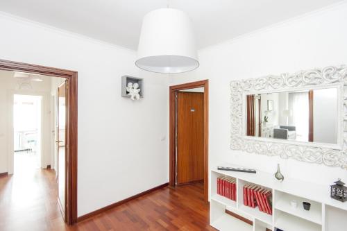 a white room with a mirror and a hallway at La Residenza Degli Angeli in Rome
