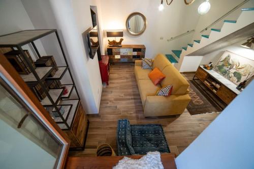 a living room with a couch and a staircase at L'Oasi nel Borgo in Monteroduni
