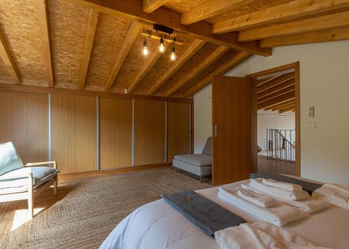 a bedroom with a bed with towels on it at HUGS Nature Retreat Heated Pool & Jacuzzi in Vila Verde