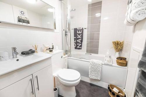 a white bathroom with a toilet and a sink at Modern 2 bedroom Flat in Montrose in Montrose