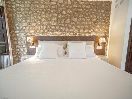 a bedroom with a large bed with white pillows at Ca'n Puig de Sòller in Sóller