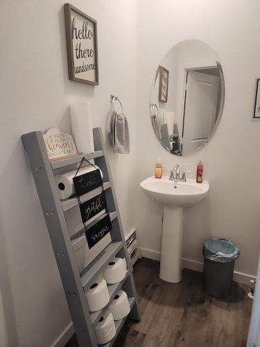 a bathroom with a ladder next to a sink and a mirror at Cozy, Quiet Shared Room & Home in Watkins