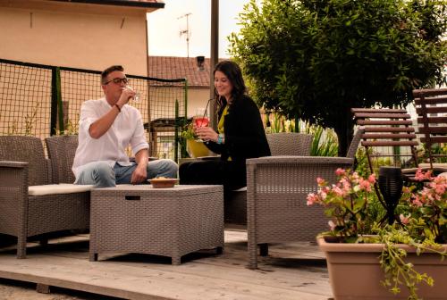 a man and a woman sitting in chairs on a patio at Nido di Faggio in Borsoi