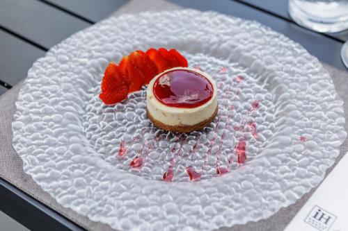 a cake on a paper plate with a dessert on it at iH Hotels Milano Lorenteggio in Milan