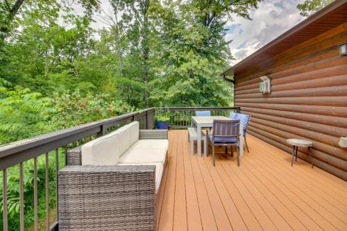 a wooden deck with a table and chairs on it at Beautiful Breezy Point Home with Beach and Dock! in Pequot Lakes