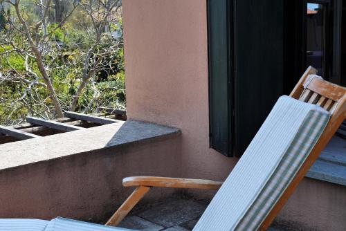 two chairs sitting on the porch of a house at Chorto Garden Home in Chorto