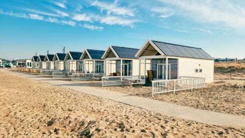 a row of beach houses on the beach at Kusthuisjes in Katwijk