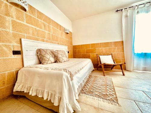 a bedroom with a bed and a brick wall at Masseria dei Monaci in Otranto