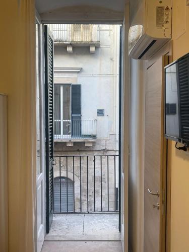an open door to a balcony with a view of a building at ROOMS69-Francesca in Corato