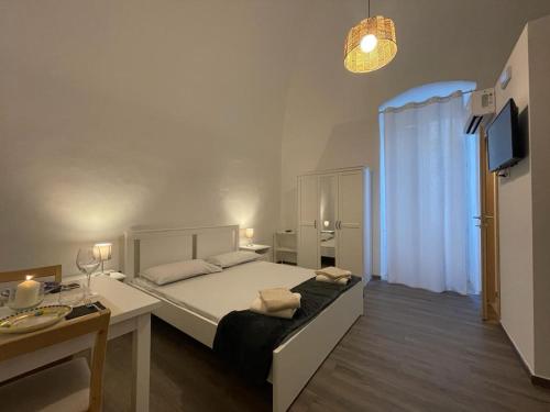 Dormitorio con cama, escritorio y TV en ROOMS69-Francesca en Corato