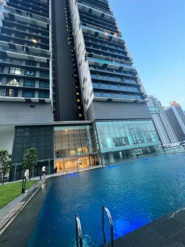 a swimming pool in front of a tall building at Setia Sky 88 @D'miko Home Stay in Johor Bahru