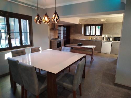 a kitchen with a dining room table and chairs at oeiras Lagoas Parque ,elite home in Porto Salvo