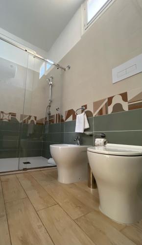 a bathroom with a toilet and a sink at 38 Aira Hotels in Palermo