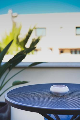 a table with a remote control sitting on top of it at RIAD Comfort Rooms in San Vito lo Capo