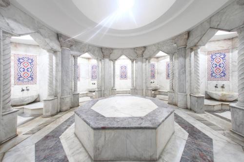 a room with a table in the middle of a building at Afyon MCG Marble Hotel in Afyon