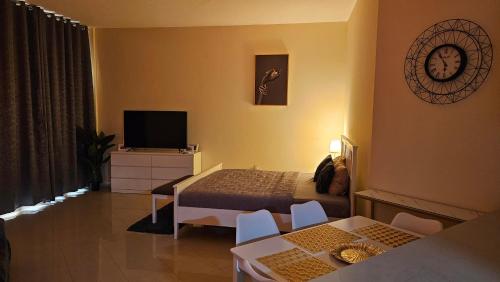 a hotel room with a bed and a television at Full Sea view studio in Ras al Khaimah