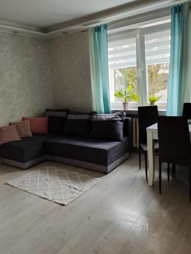 a living room with a couch and a table at Apartament Agata in Giżycko