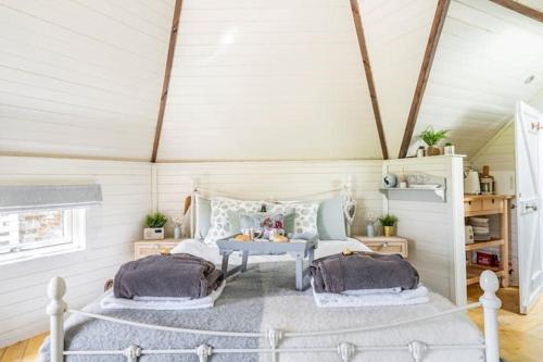 a bedroom with a bed and a table in a room at South Barlogan Farm in Bridge of Weir