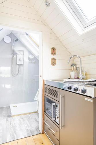 a bathroom with a shower and a sink and a shower at South Barlogan Farm in Bridge of Weir