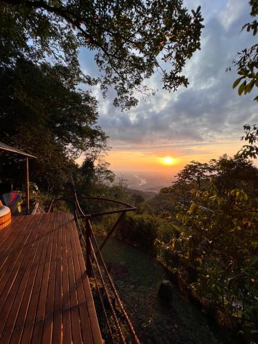 a view of a sunset from the deck of a house at Senderos Glamping in Villavicencio